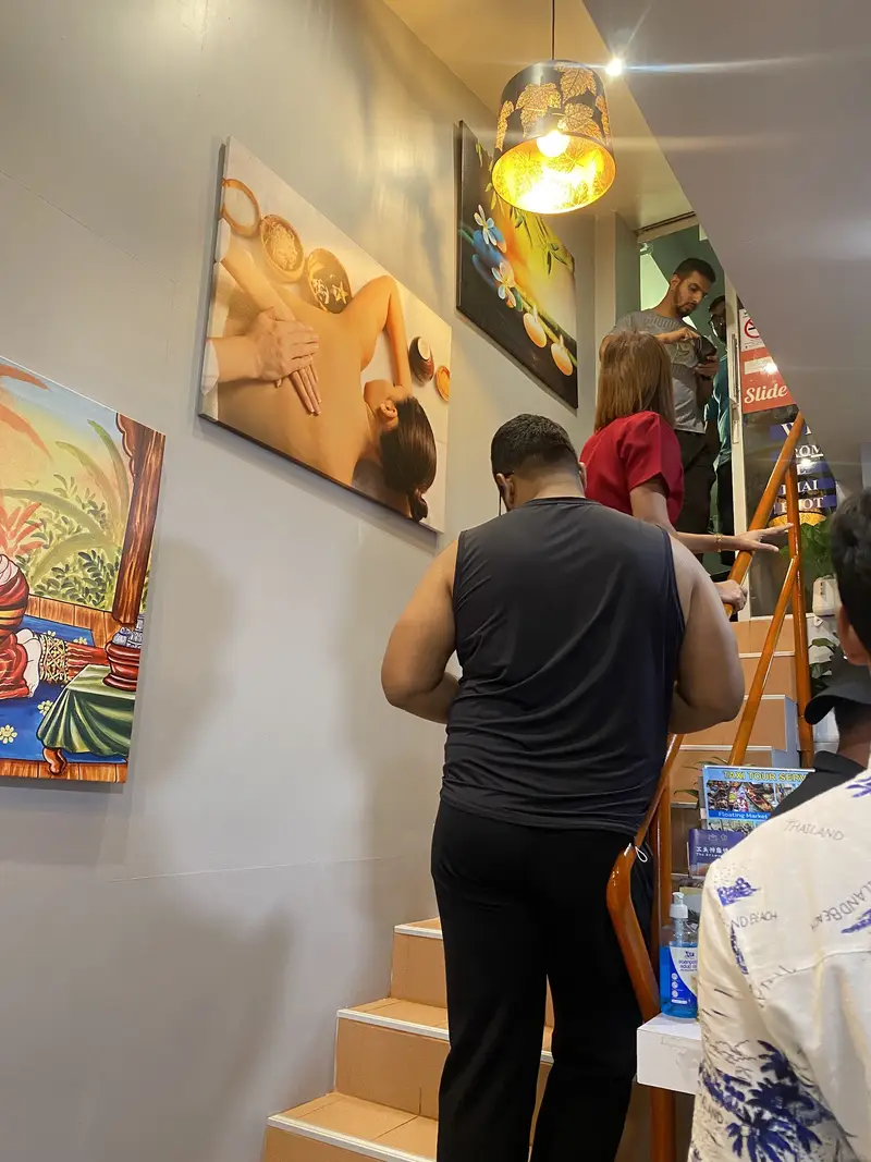 Stairway up to the shop with paintings and gold lantern lamps